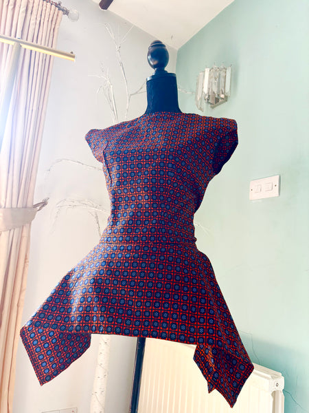 Zena Handkerchief hem peplum top in a vibrant contemporary geometric African print.