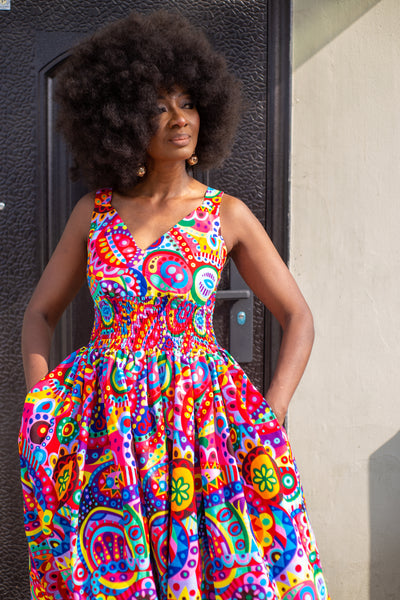 Fatu full skirt dress in multicoloured abstract pattern.