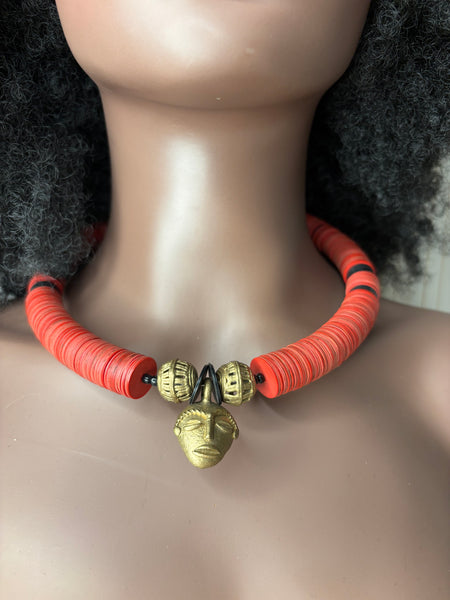 Yuya choker in coral with a bronze African mask pendant.