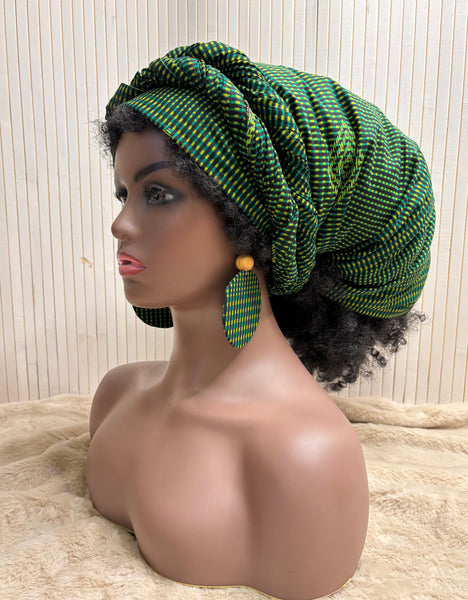 African print head wrap and large disc earrings in a green geometric print.