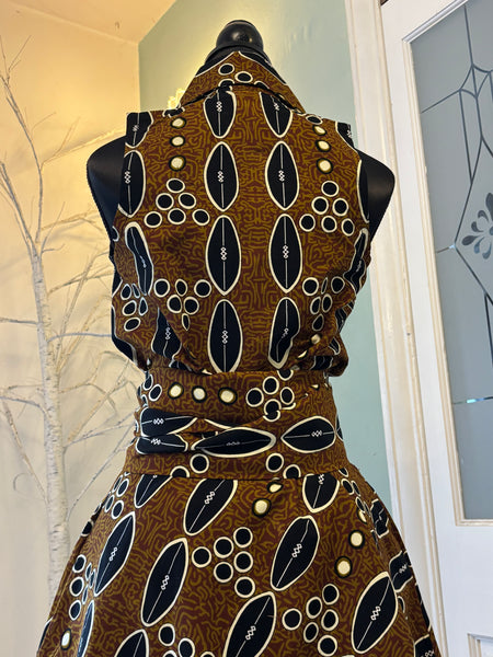 Shali sleeveless dress in a contemporary African print in brown.