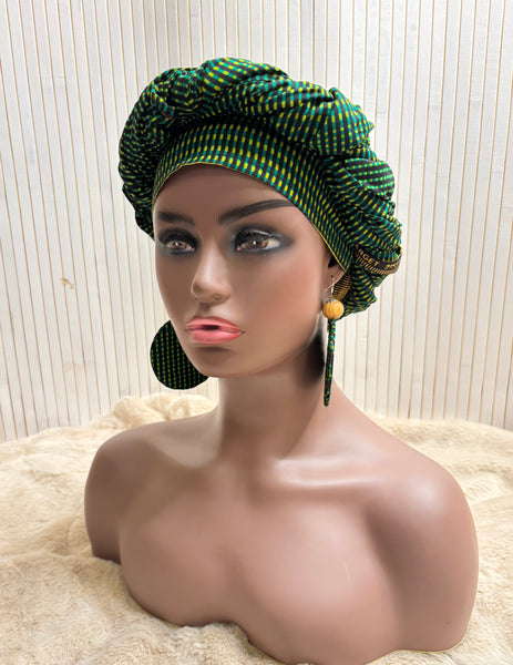 African print head wrap and large disc earrings in a green geometric print.