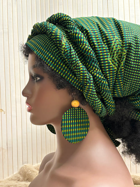 African print head wrap and large disc earrings in a green geometric print.