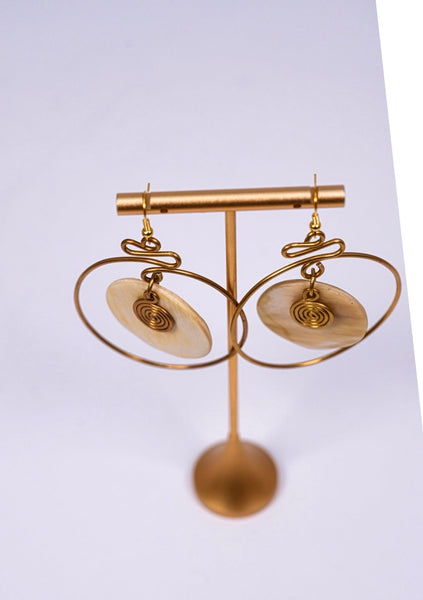 Yuri brass and bone dangling earrings with swirl detail.