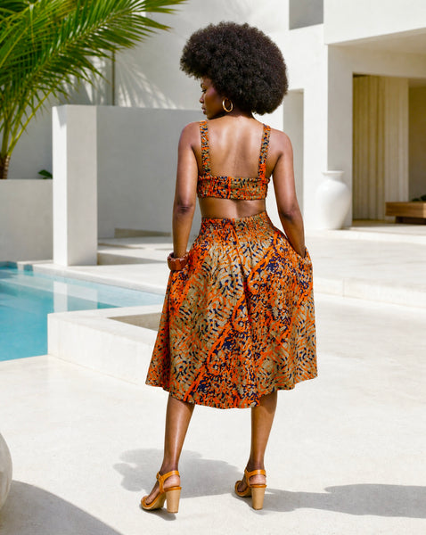 Yiko cut out dress in red and brown hues.