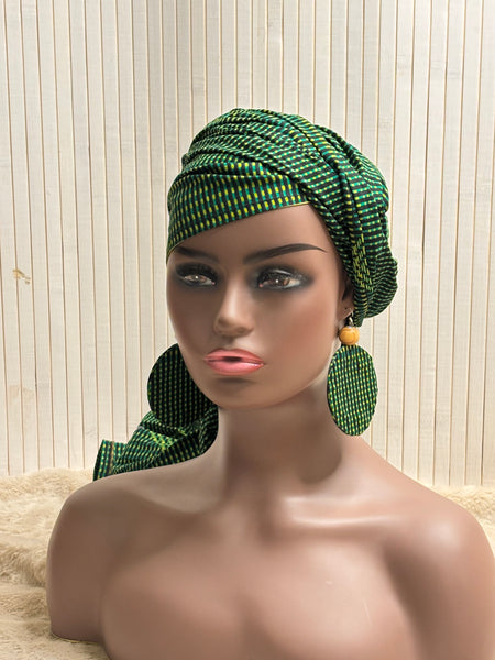 African print head wrap and large disc earrings in a green geometric print.