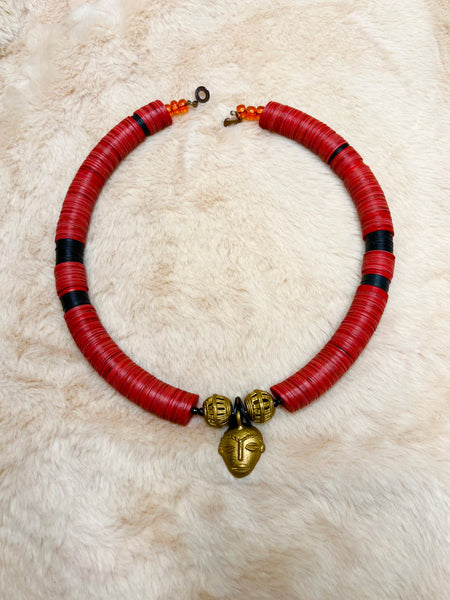 Yuya choker in coral with a bronze African mask pendant.