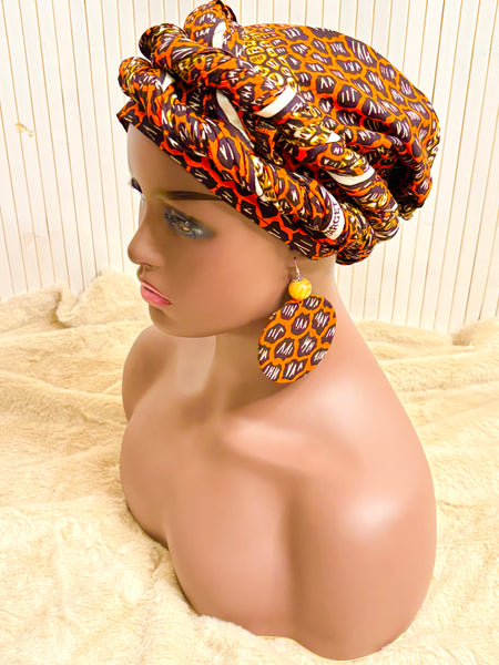 African print head wrap and large disc earrings set in an orange geometric vintage print.