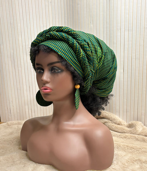 African print head wrap and large disc earrings in a green geometric print.