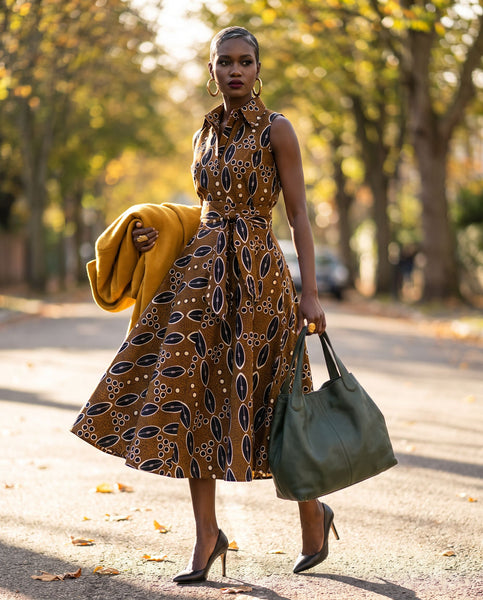 Shali sleeveless dress in a contemporary African print in brown.