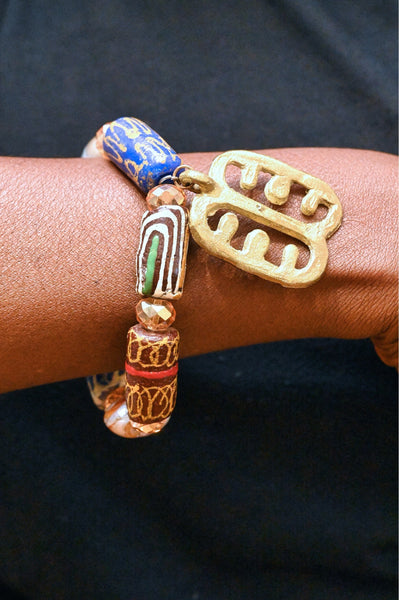 Stretch bracelet with traditional beads and Adinkra pendant.