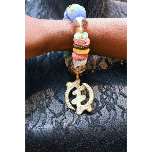 Recycled glass beads with adinkra pendant.