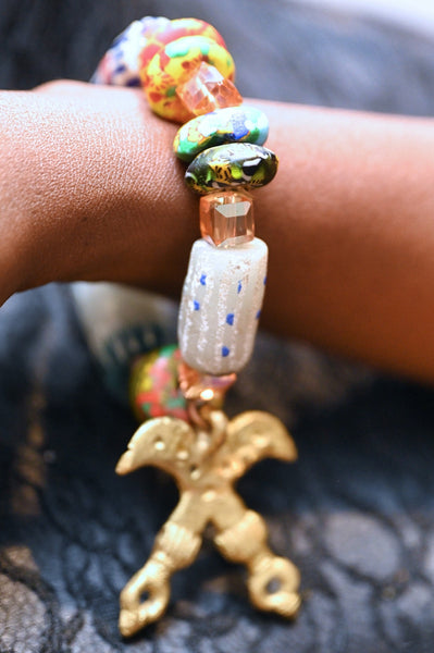 Recycled glass beads with adinkra pendant.